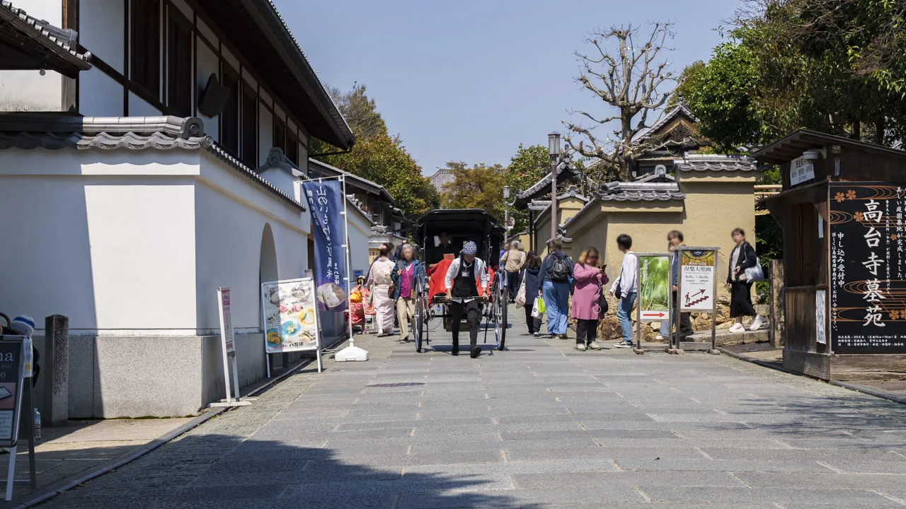 ねねの道を歩く観光客と、圓徳院の白い土塀。京都東山の散策の途中でふと立ち止まりたくなる入口